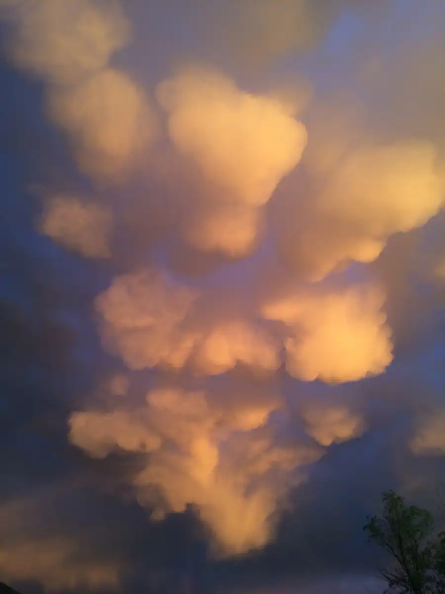 White billowy clouds stand out amoungst gray ones.